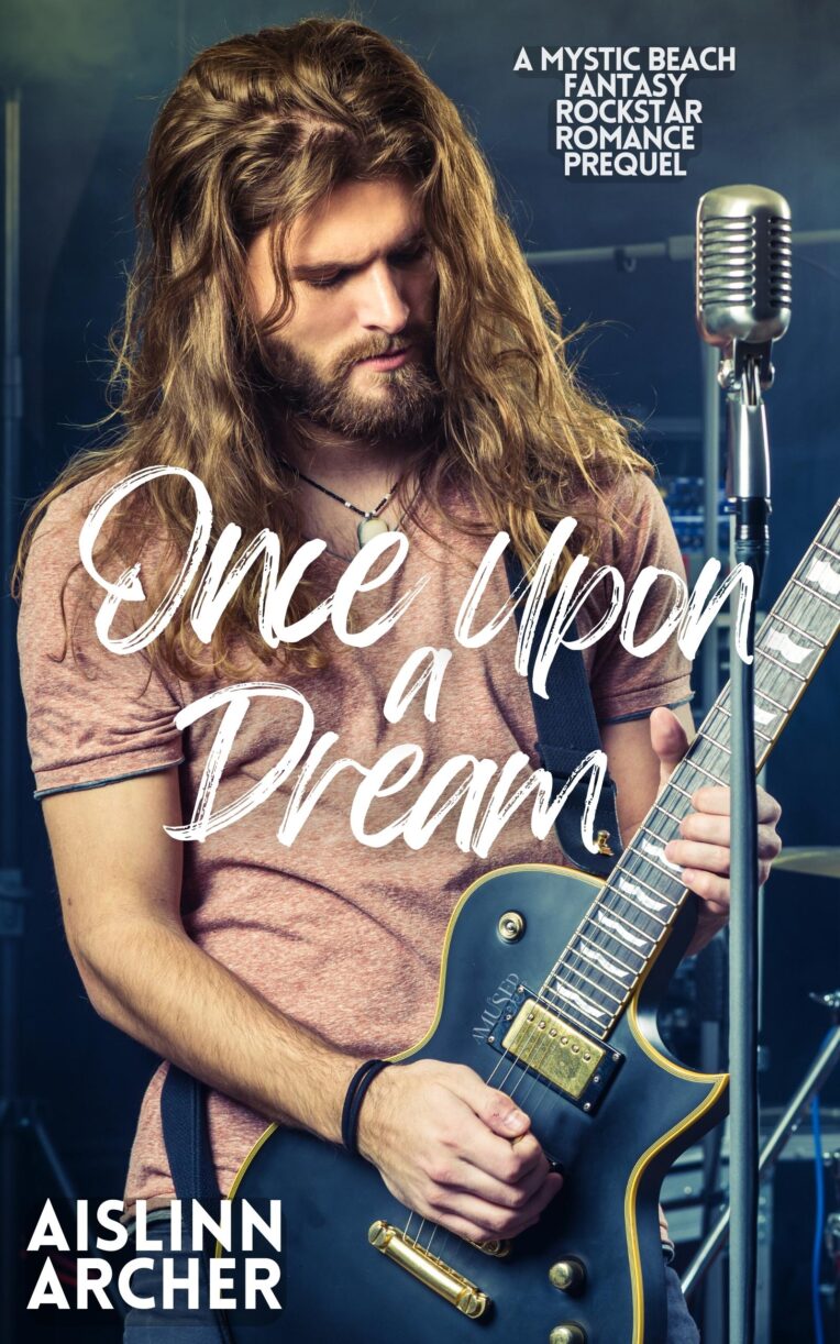 Book cover for 'Once Upon a Dream' Mystic Beach Fantasy Rockstar Romance novel by Aislinn Archer, featuring long-haried man playing electirc guitar next to a microphone